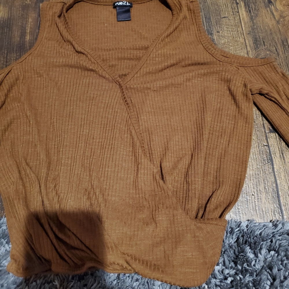 A brown shirt with shoulder exposed sleeve
